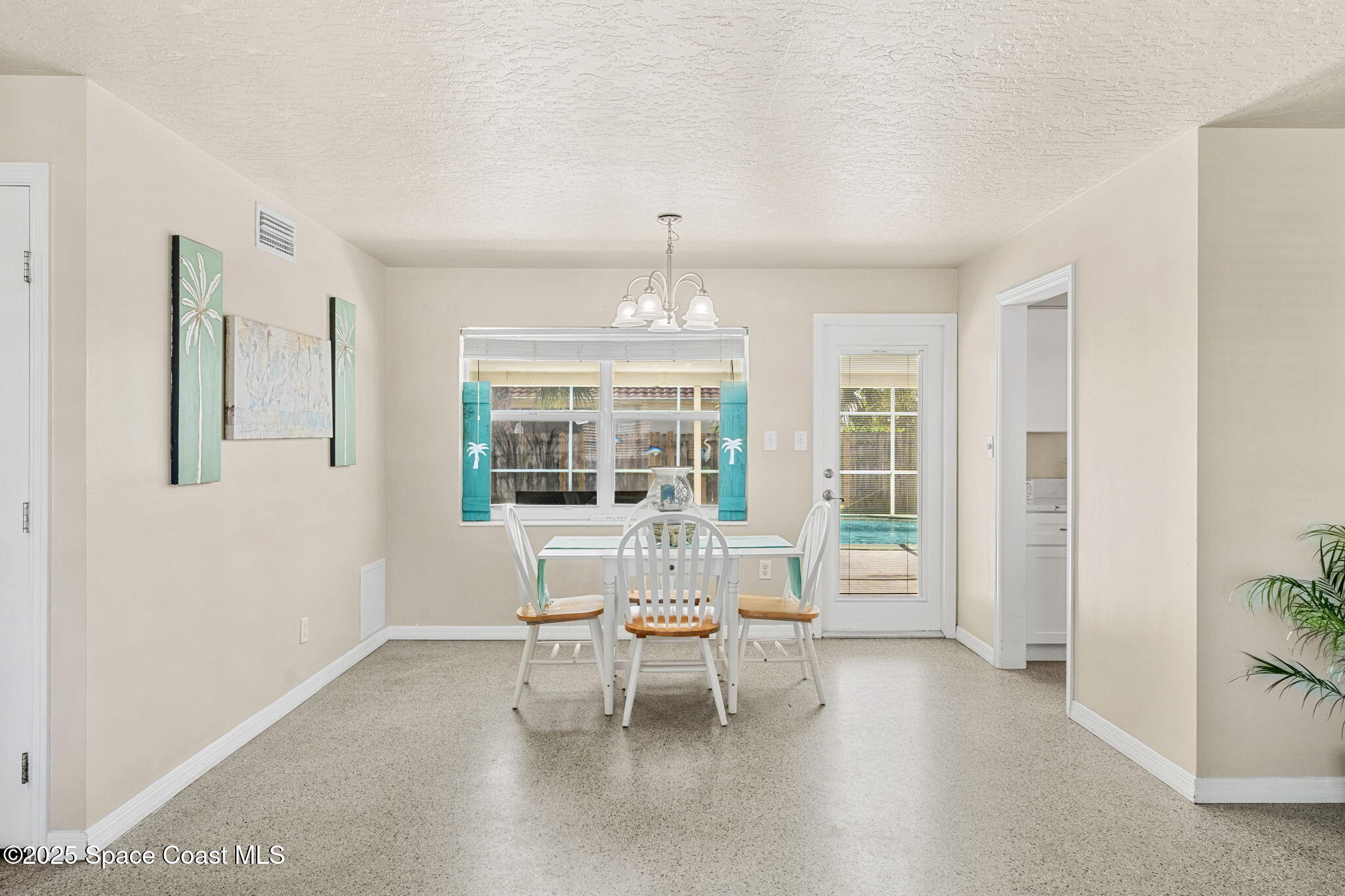141 Diane Circle Indialantic, FL 32903 - Photo 15 of 36 a living room with furniture and a chandelier