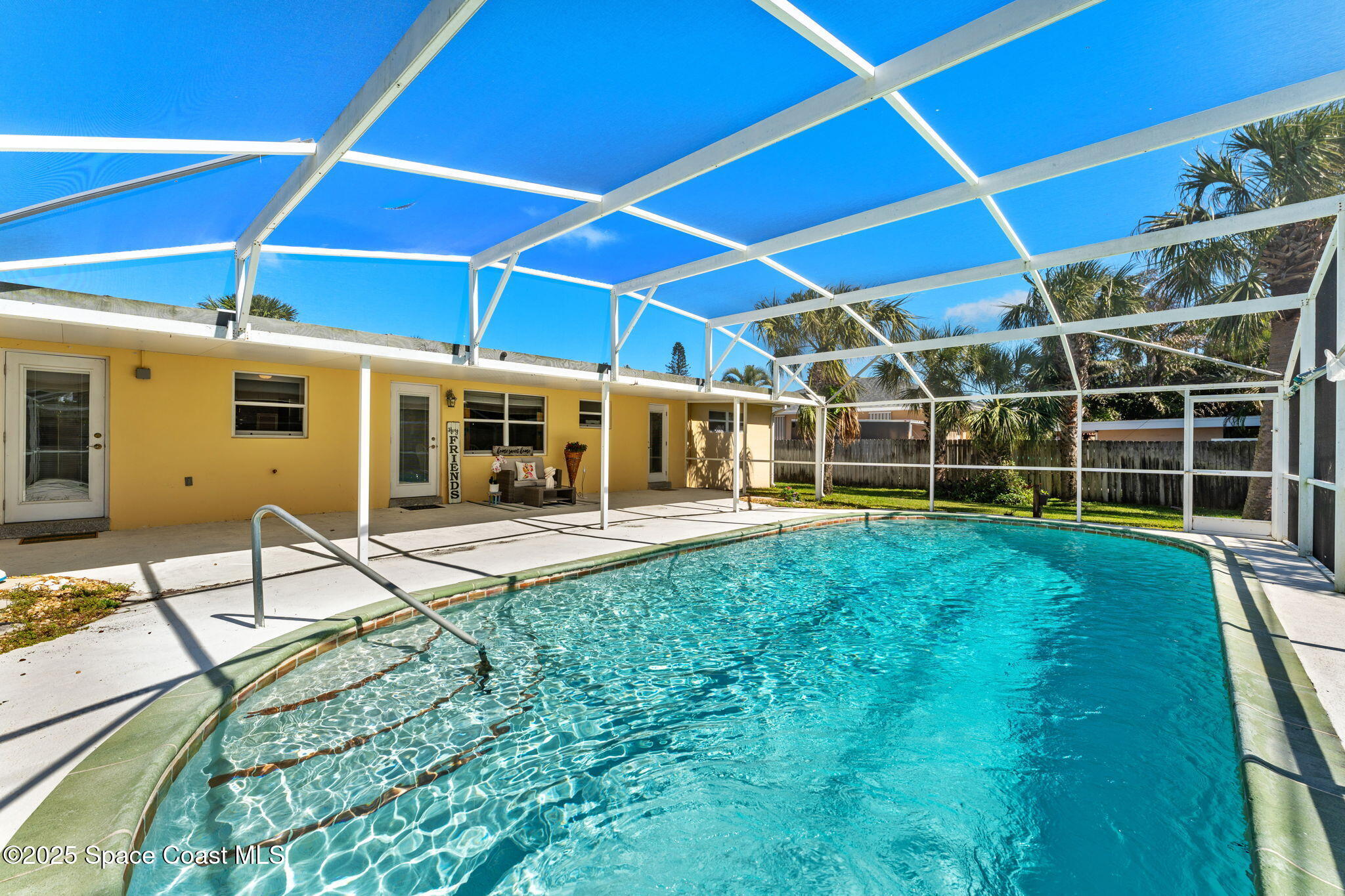141 Diane Circle Indialantic, FL 32903 - Photo 27 of 36 a view of a backyard with table and chairs under an umbrella
