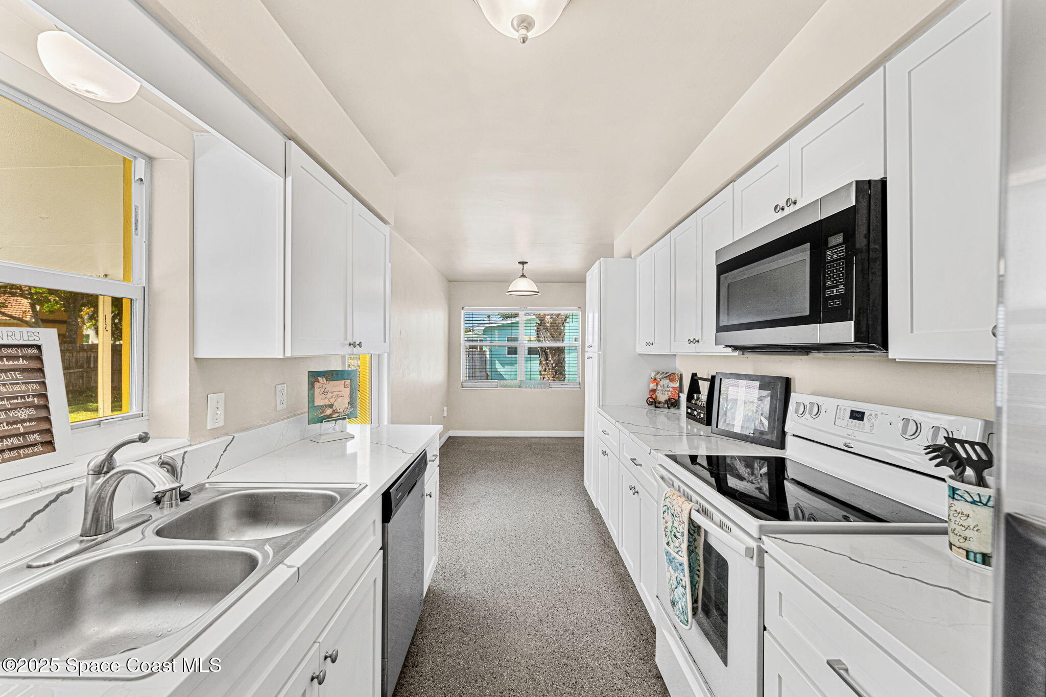 141 Diane Circle Indialantic, FL 32903 - Photo 8 of 36 a kitchen with stainless steel appliances a sink a stove and microwave
