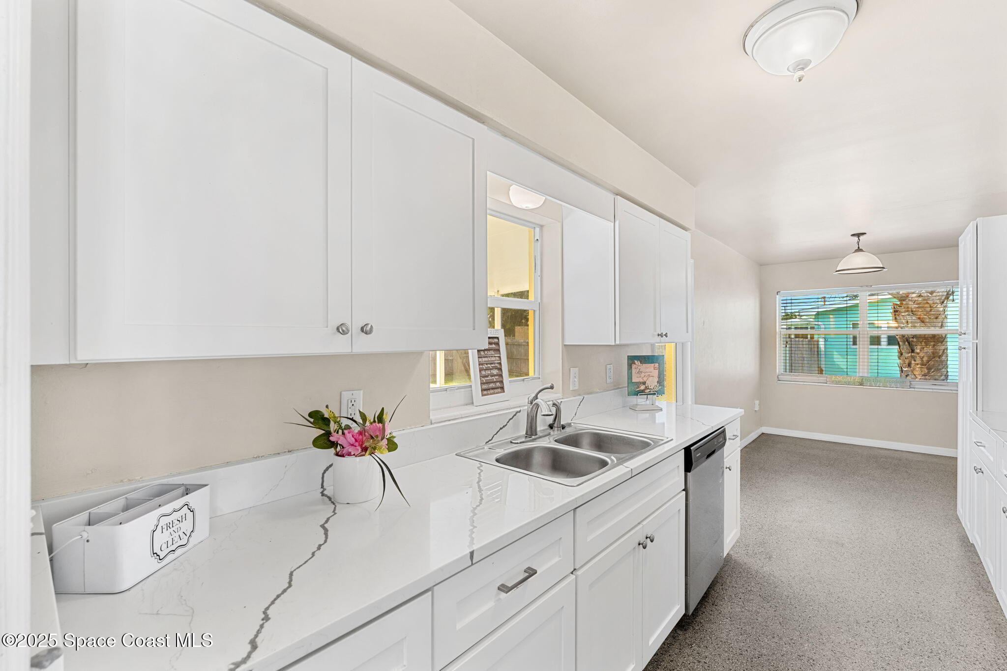 141 Diane Circle Indialantic, FL 32903 - Photo 9 of 36 a kitchen with granite countertop a sink a stove and cabinets