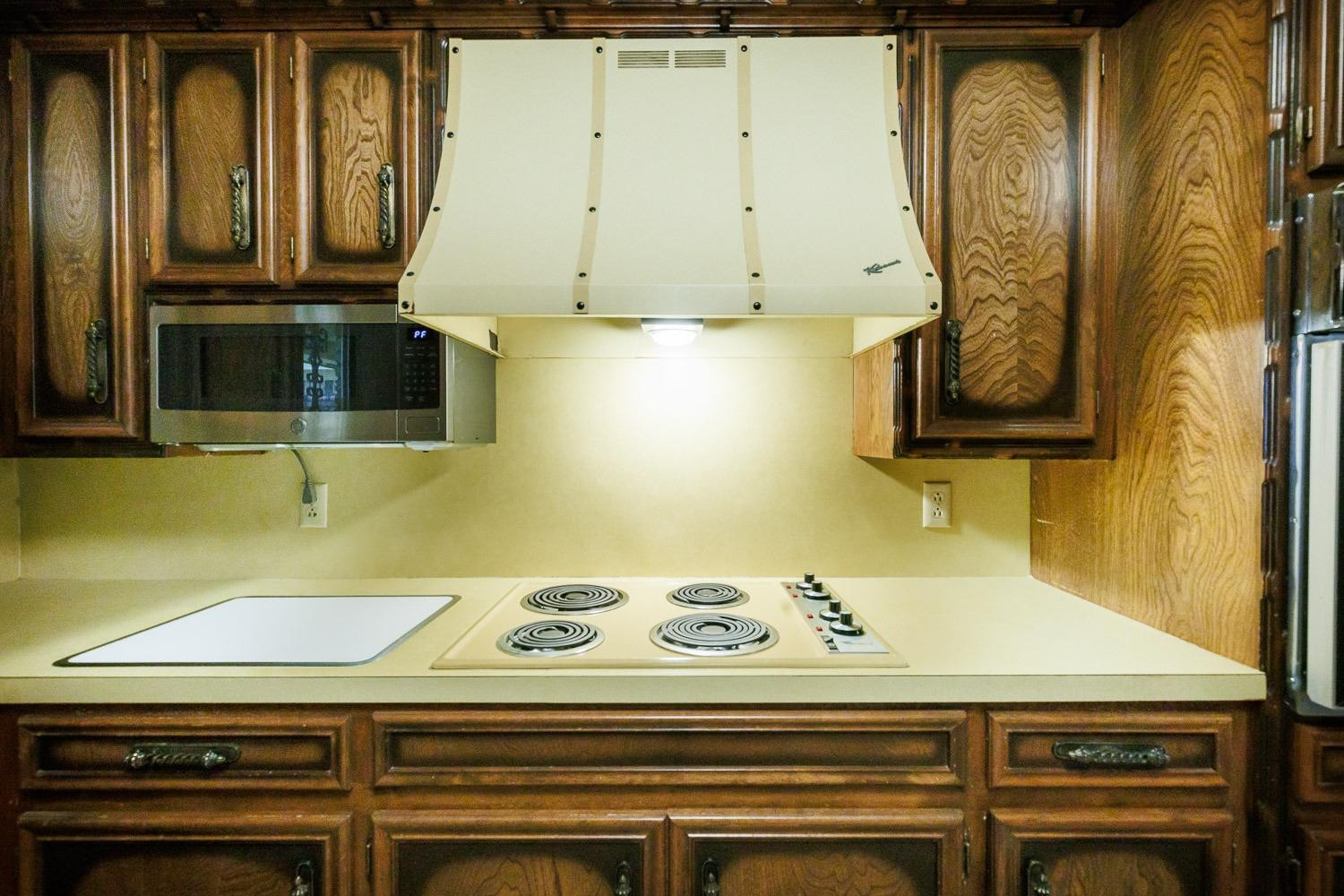 3402 79th Street Lubbock, TX 79423 - Photo 11 of 49 a kitchen with a stove and a microwave