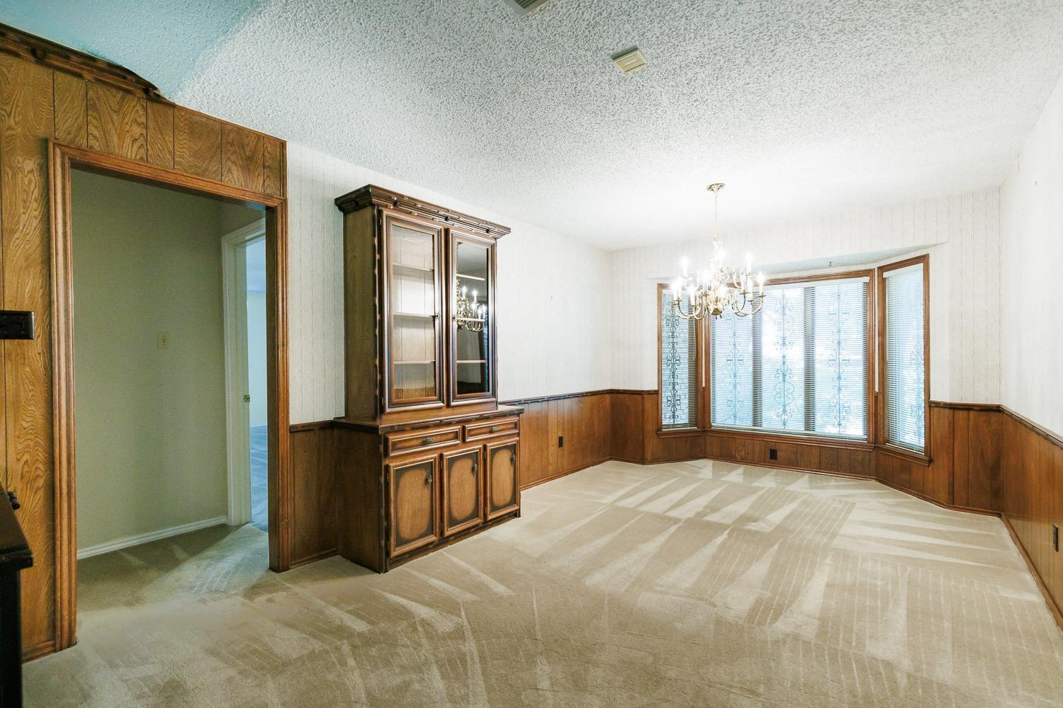 3402 79th Street Lubbock, TX 79423 - Photo 15 of 49 a large bedroom with a large bed and dresser