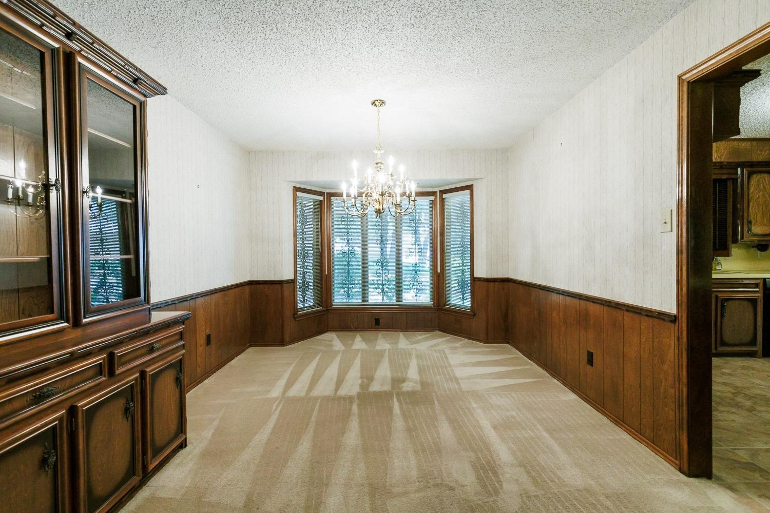 3402 79th Street Lubbock, TX 79423 - Photo 16 of 49 a spacious bedroom with a bed and a flat tv screen on dresser