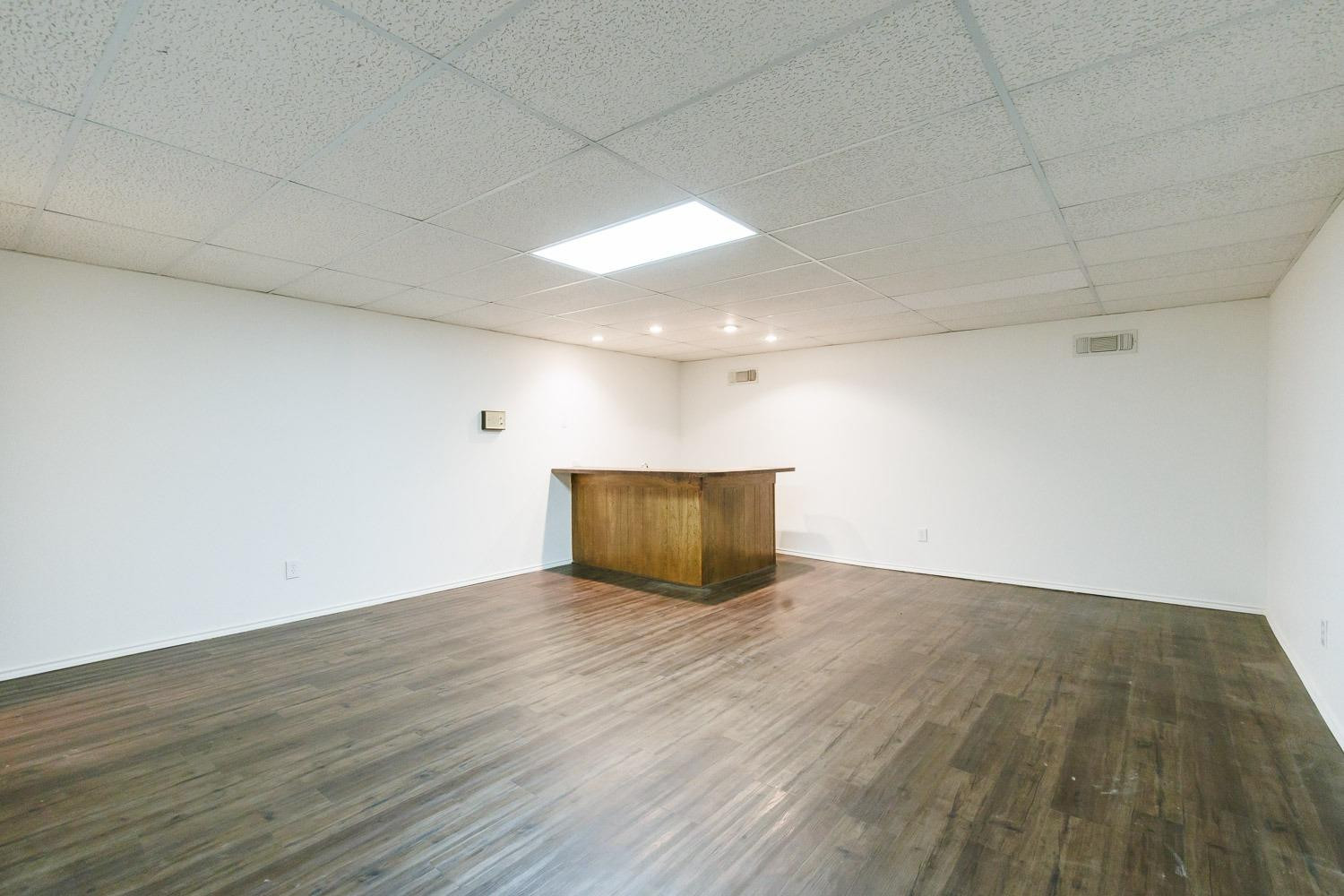 3402 79th Street Lubbock, TX 79423 - Photo 19 of 49 a view of an empty room with wooden floor
