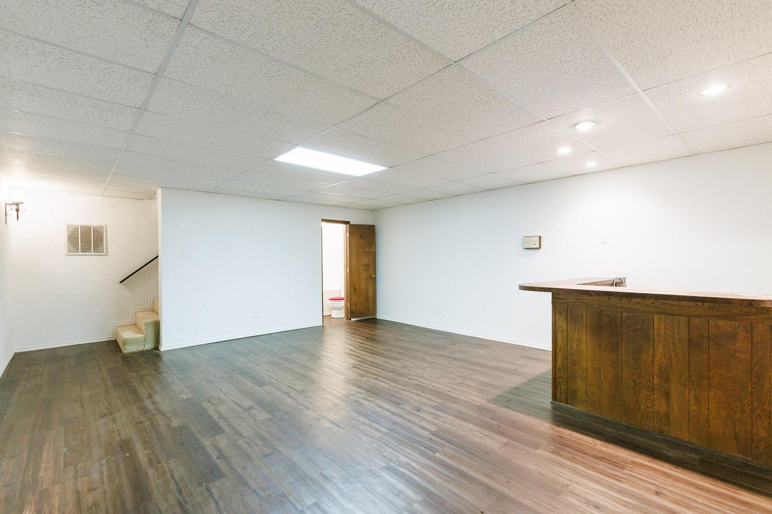 3402 79th Street Lubbock, TX 79423 - Photo 20 of 49 a view of an empty room with wooden floor