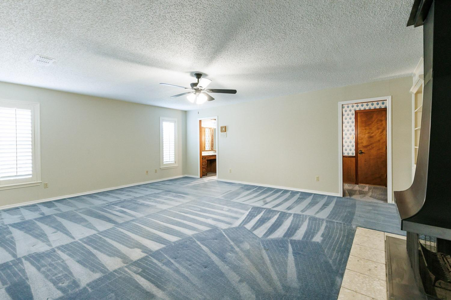 3402 79th Street Lubbock, TX 79423 - Photo 23 of 49 a view of an empty room with a chandelier
