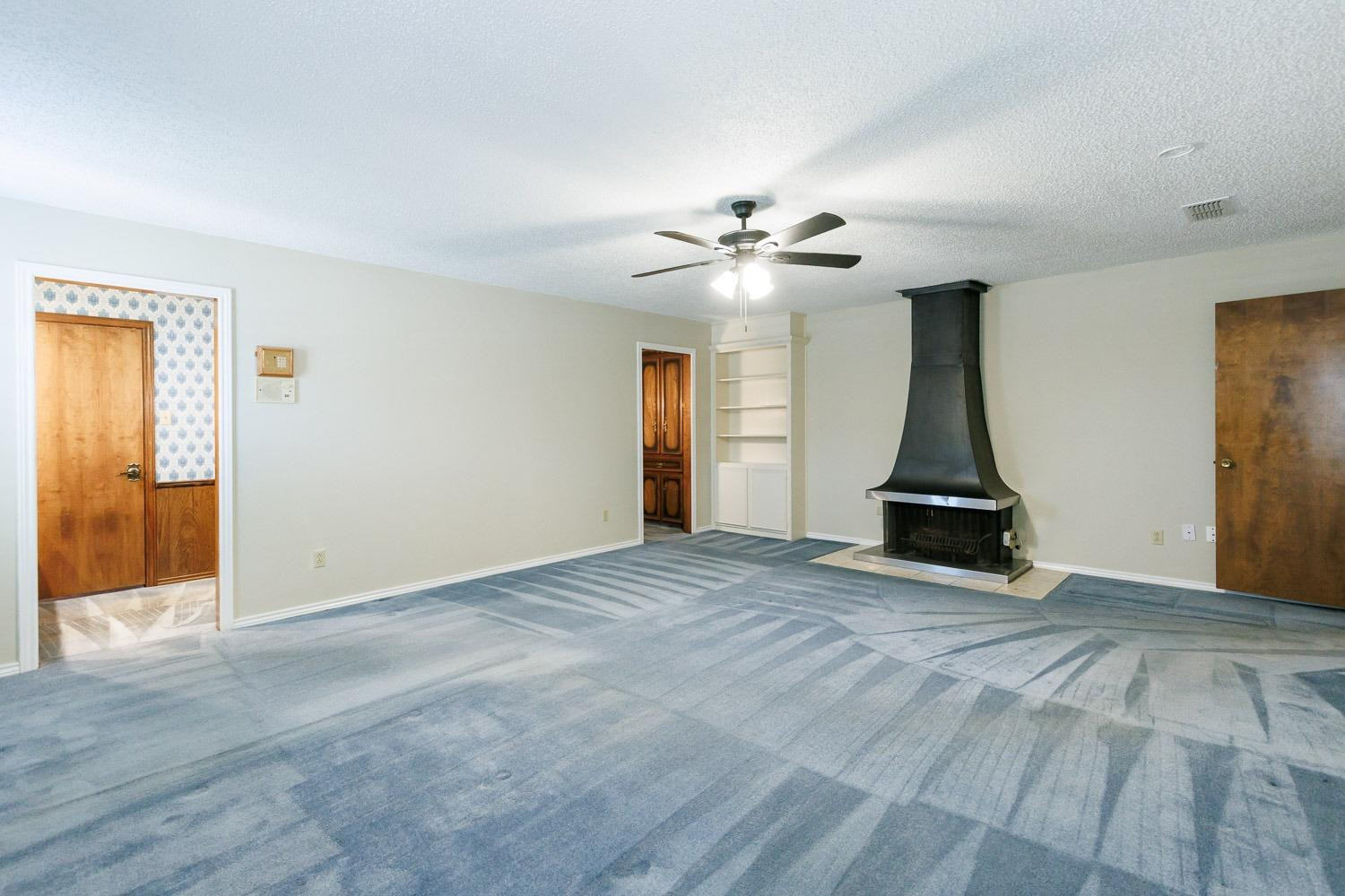 3402 79th Street Lubbock, TX 79423 - Photo 24 of 49 a view of an empty room with window and a kitchen