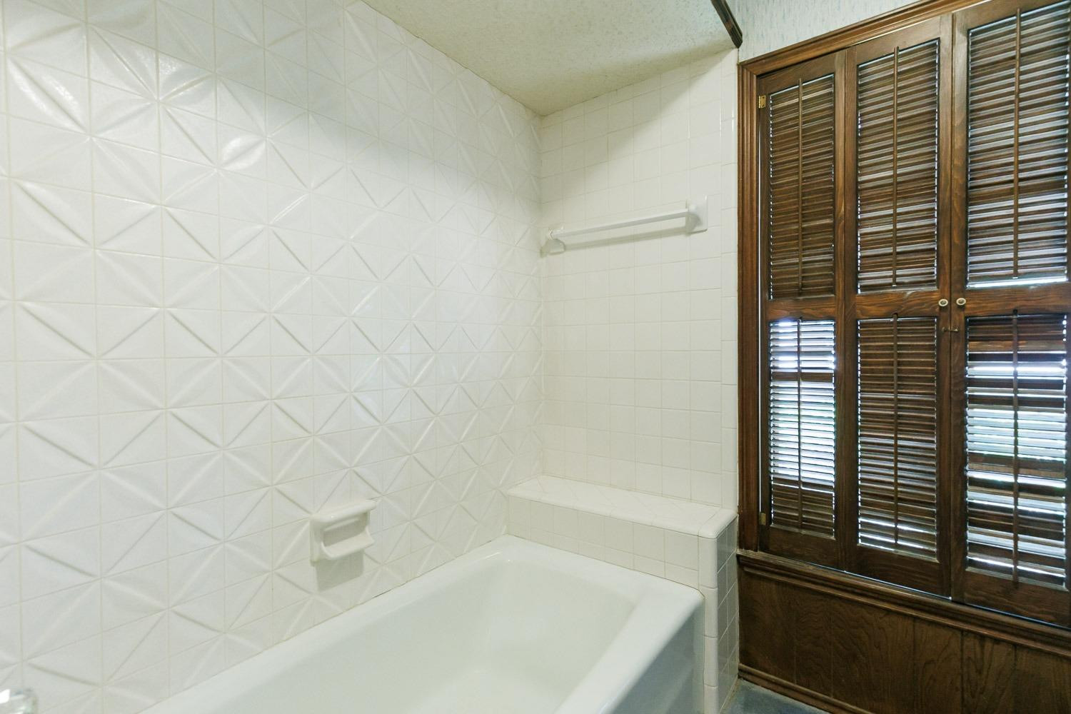 3402 79th Street Lubbock, TX 79423 - Photo 27 of 49 a bathroom with a bathtub
