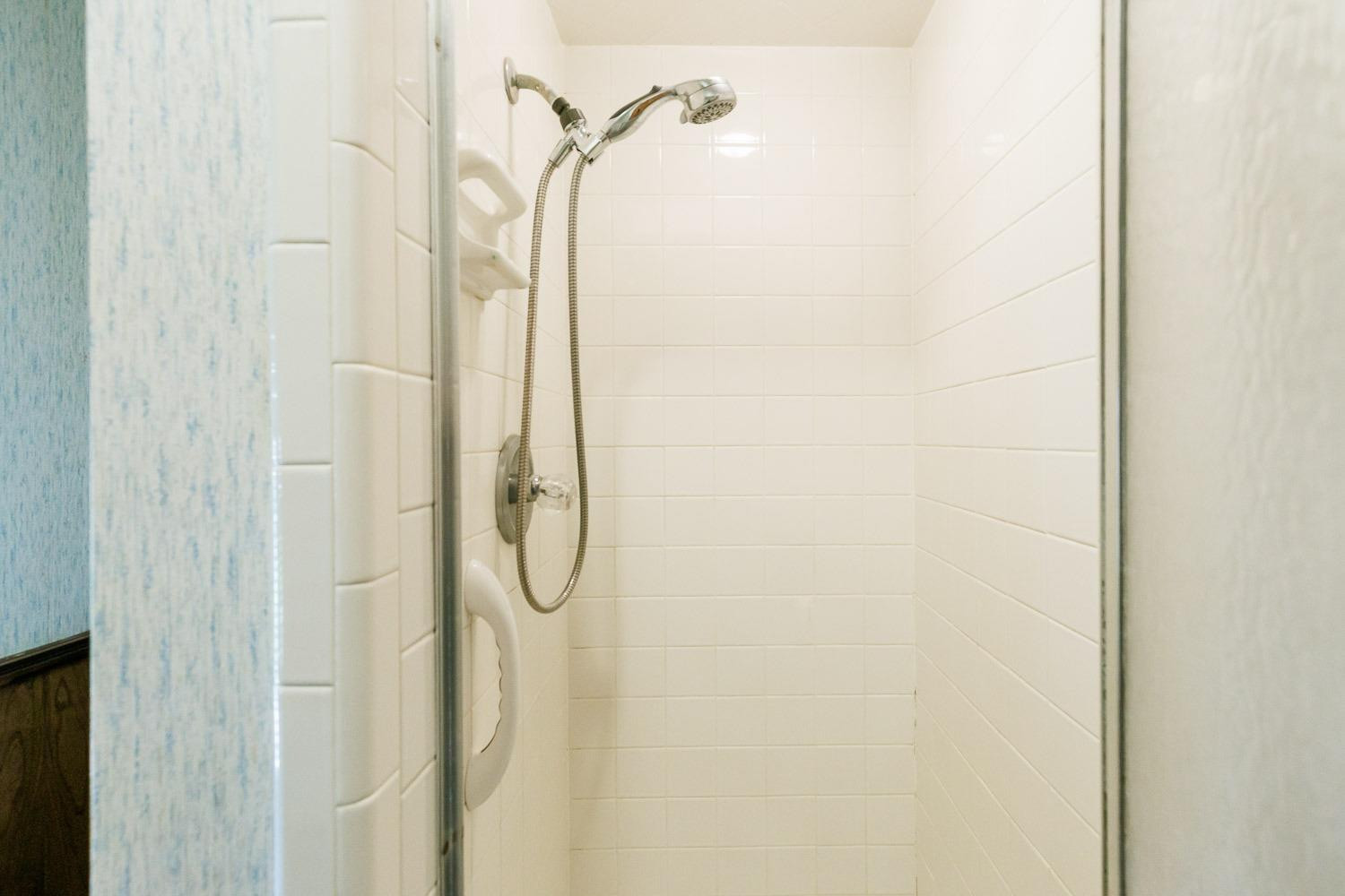 3402 79th Street Lubbock, TX 79423 - Photo 28 of 49 a bathroom with a glass shower door