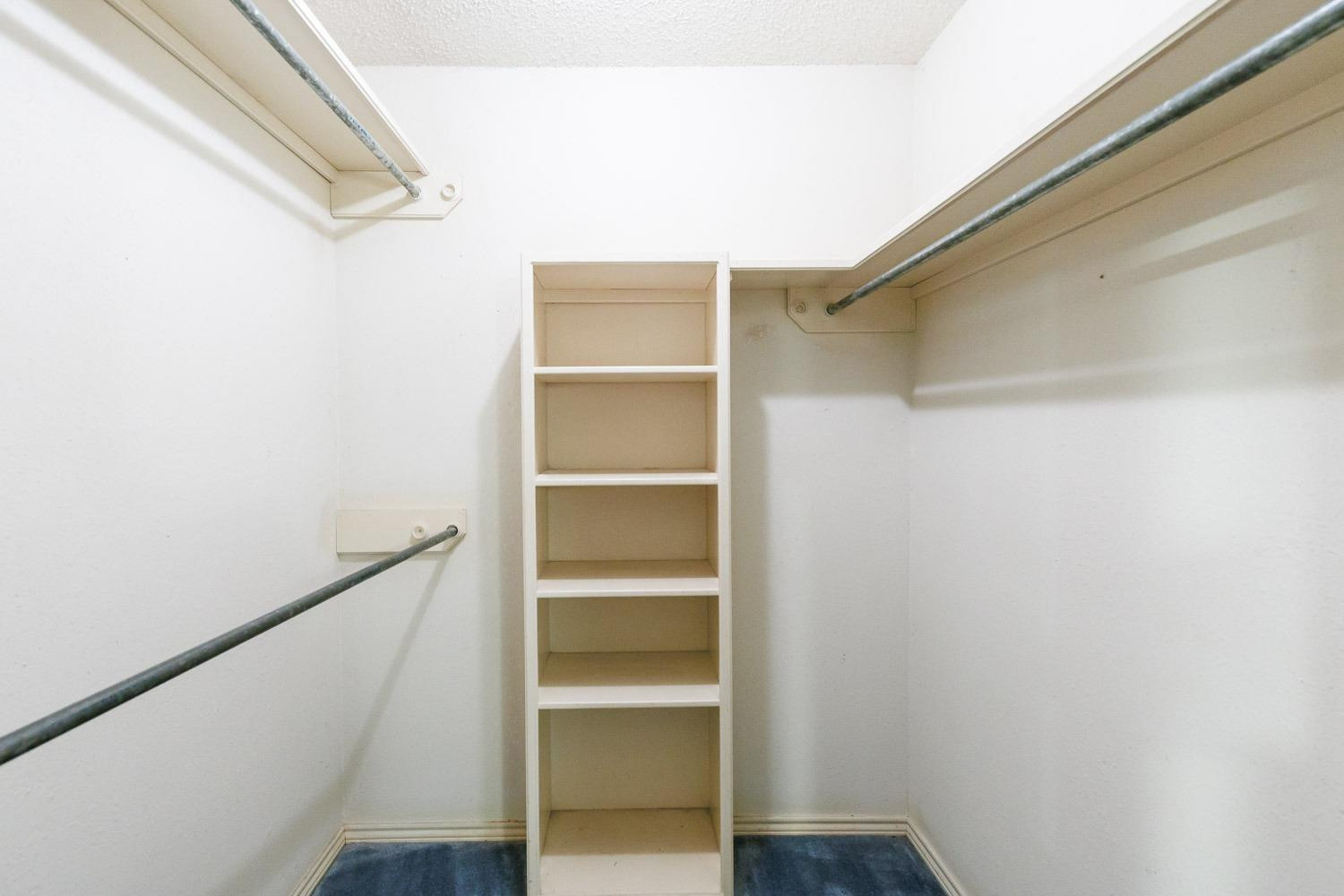 3402 79th Street Lubbock, TX 79423 - Photo 29 of 49 a view of walk in closet with empty racks