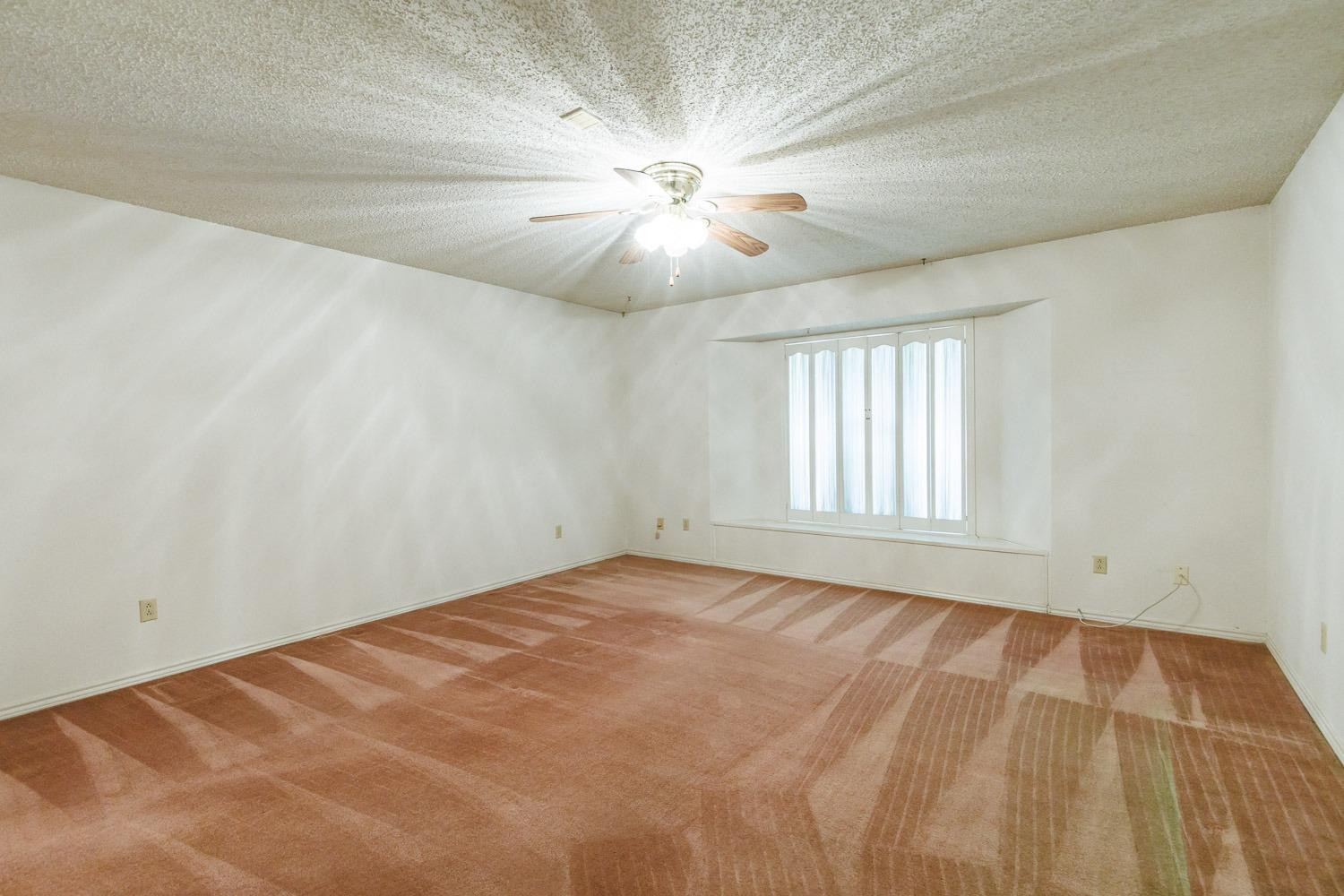 3402 79th Street Lubbock, TX 79423 - Photo 30 of 49 an empty room with windows and fan