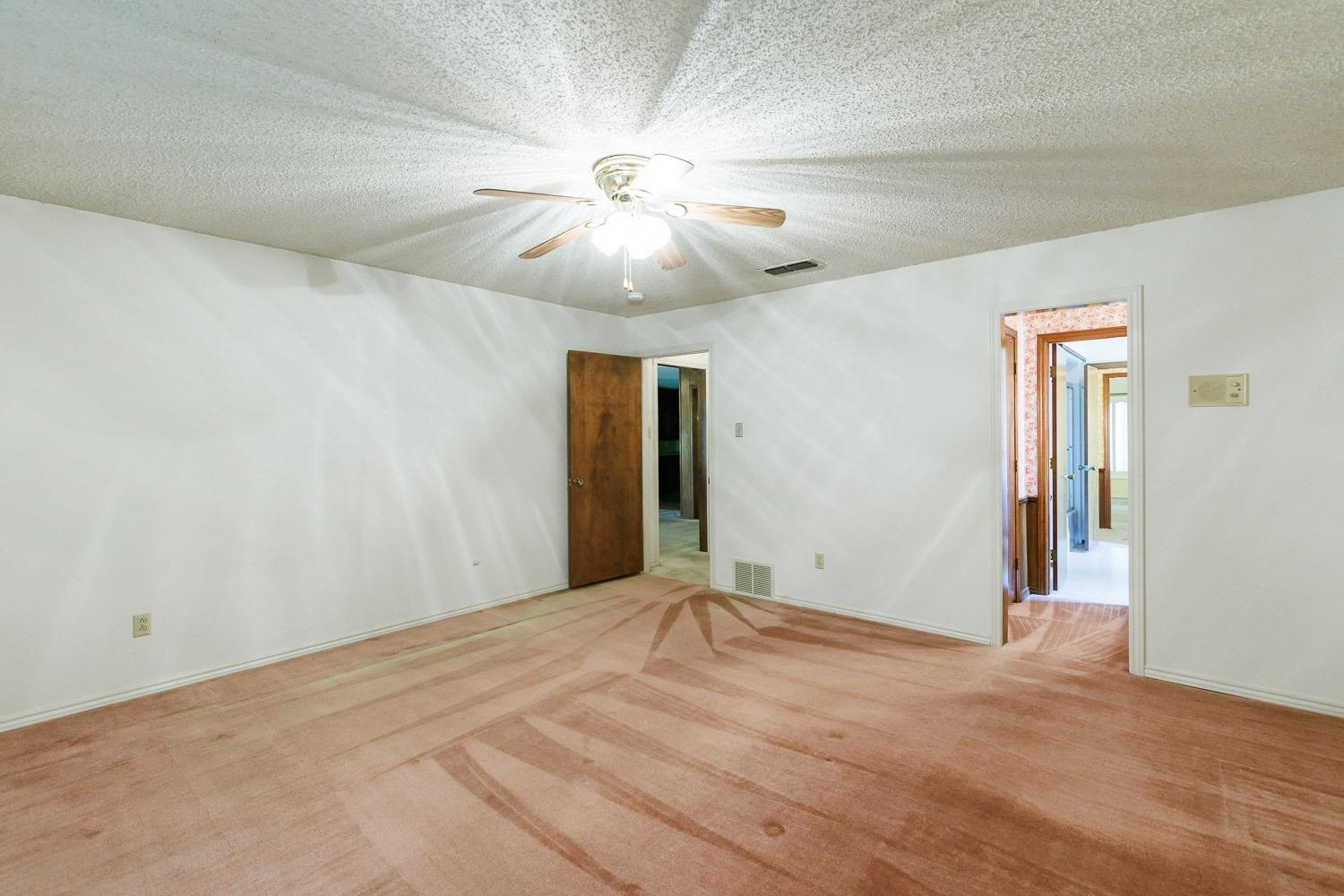 3402 79th Street Lubbock, TX 79423 - Photo 31 of 49 a view of an empty room with a ceiling fan