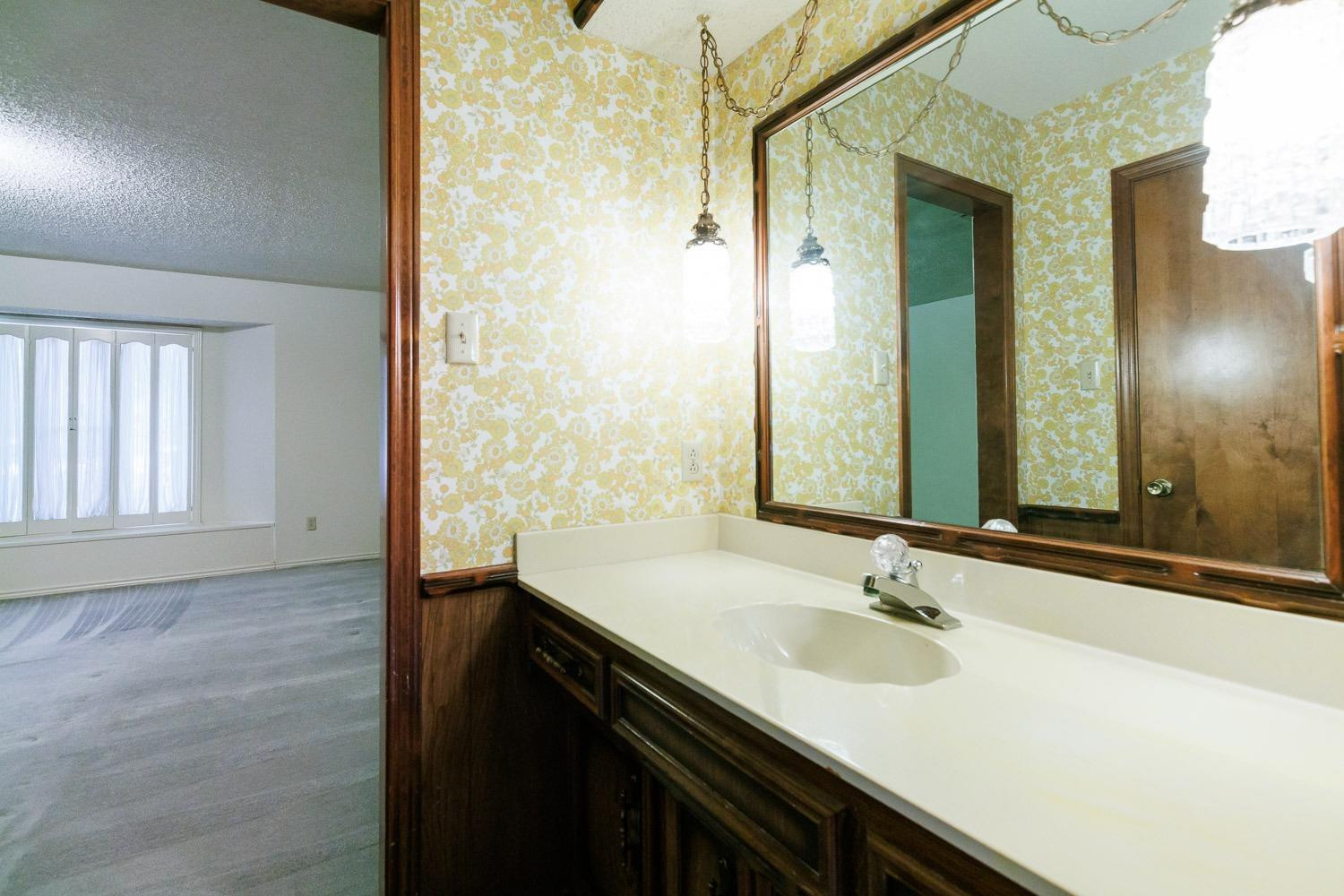 3402 79th Street Lubbock, TX 79423 - Photo 35 of 49 a bathroom with a sink and a mirror