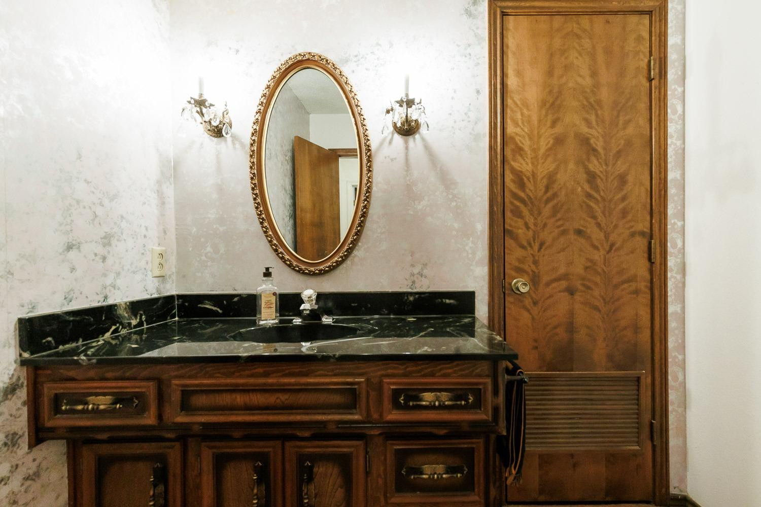 3402 79th Street Lubbock, TX 79423 - Photo 40 of 49 a bathroom with a sink and a mirror