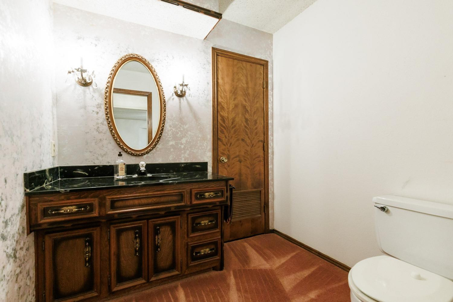 3402 79th Street Lubbock, TX 79423 - Photo 41 of 49 a bathroom with a toilet and a sink