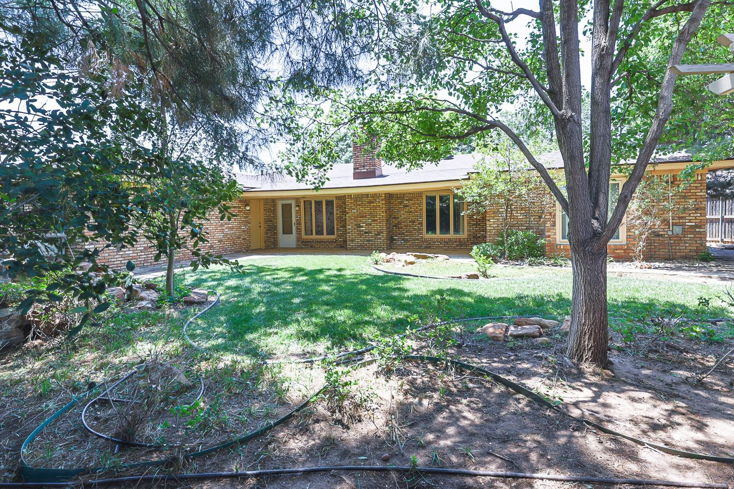 3402 79th Street Lubbock, TX 79423 - Photo 47 of 49 a front view of a house with garden