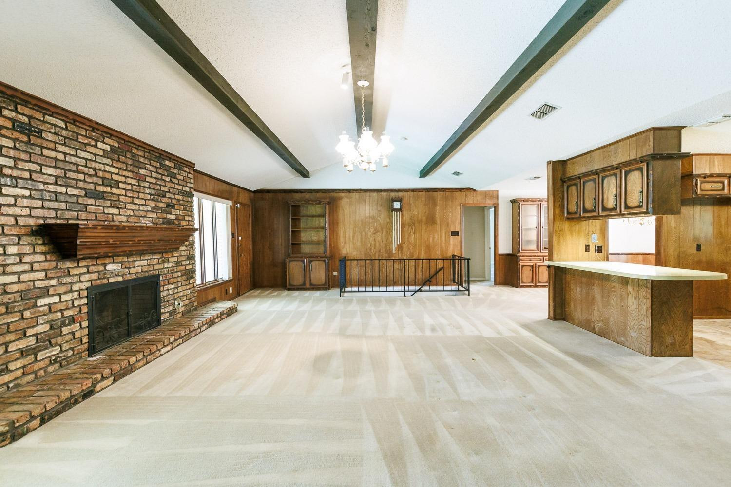3402 79th Street Lubbock, TX 79423 - Photo 7 of 49 a view of an empty room with a fireplace