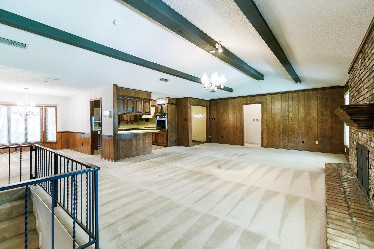 3402 79th Street Lubbock, TX 79423 - Photo 8 of 49 a view of a hallway with wooden floor and staircase