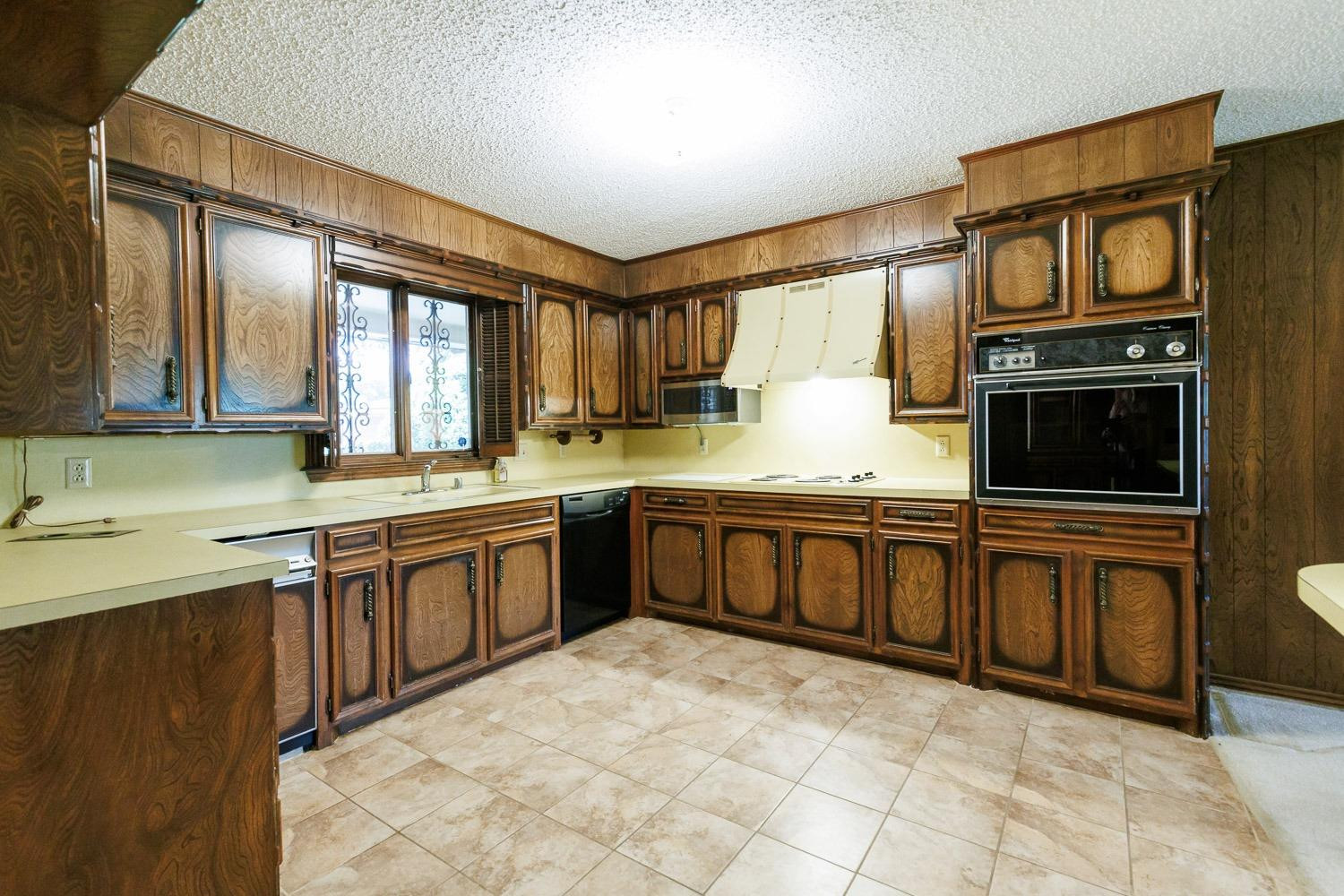 3402 79th Street Lubbock, TX 79423 - Photo 10 of 49 a kitchen with stainless steel appliances granite countertop a stove a sink and a microwave