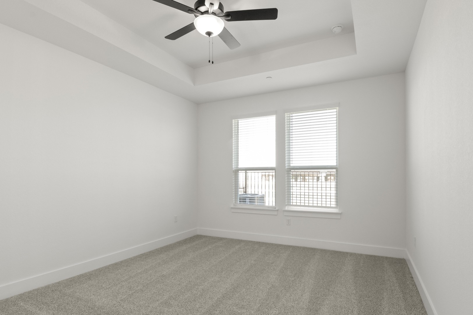 18909 Schultz Lane, Unit 1002 Round Rock, TX 78664 - Photo 18 of 24 Carpeted empty room featuring a raised ceiling and ceiling fan