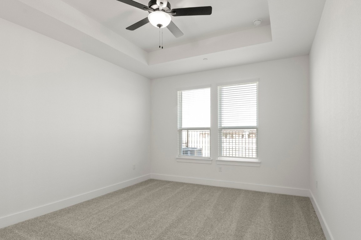 18909 Schultz Lane, Unit 1002 Round Rock, TX 78664 - Photo 18 of 24 an empty room with a window and a fan