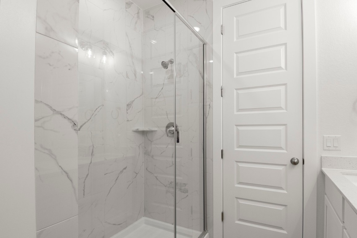 18909 Schultz Lane, Unit 1002 Round Rock, TX 78664 - Photo 21 of 24 a bathroom with a shower