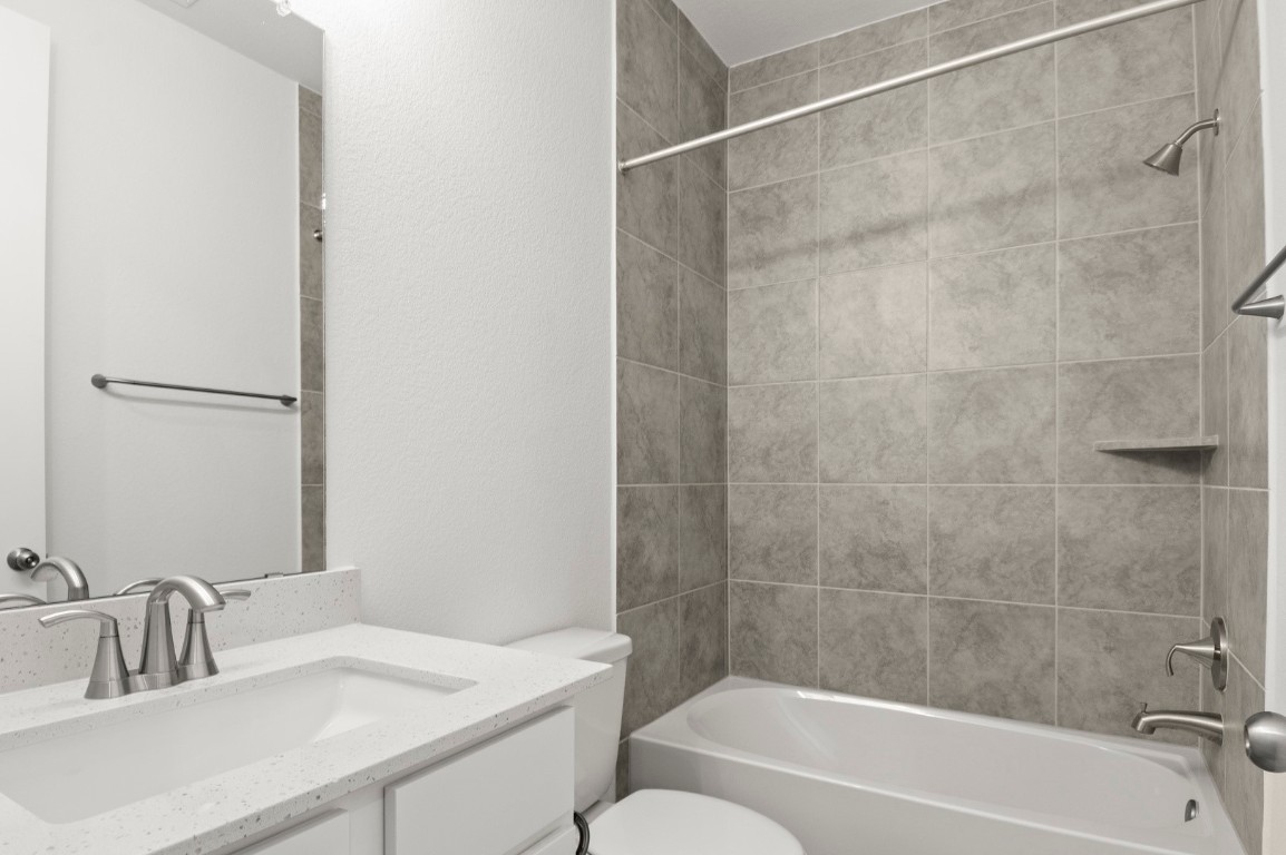 18909 Schultz Lane, Unit 1002 Round Rock, TX 78664 - Photo 22 of 24 a bathroom with a sink and a bathtub