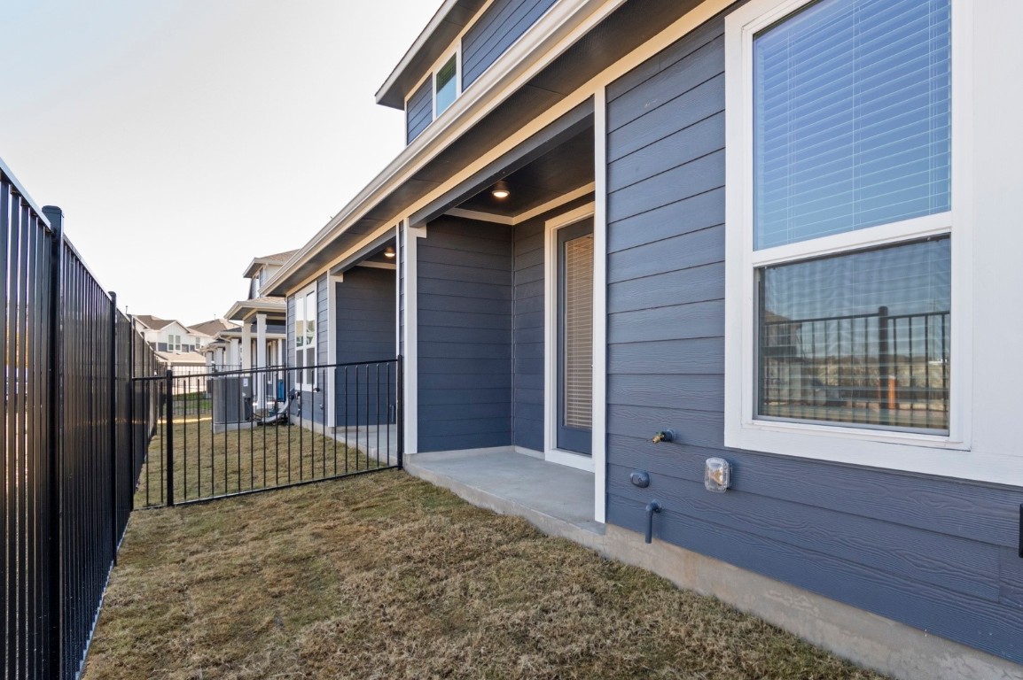 18909 Schultz Lane, Unit 1002 Round Rock, TX 78664 - Photo 23 of 24 a view of a house with a wooden fence