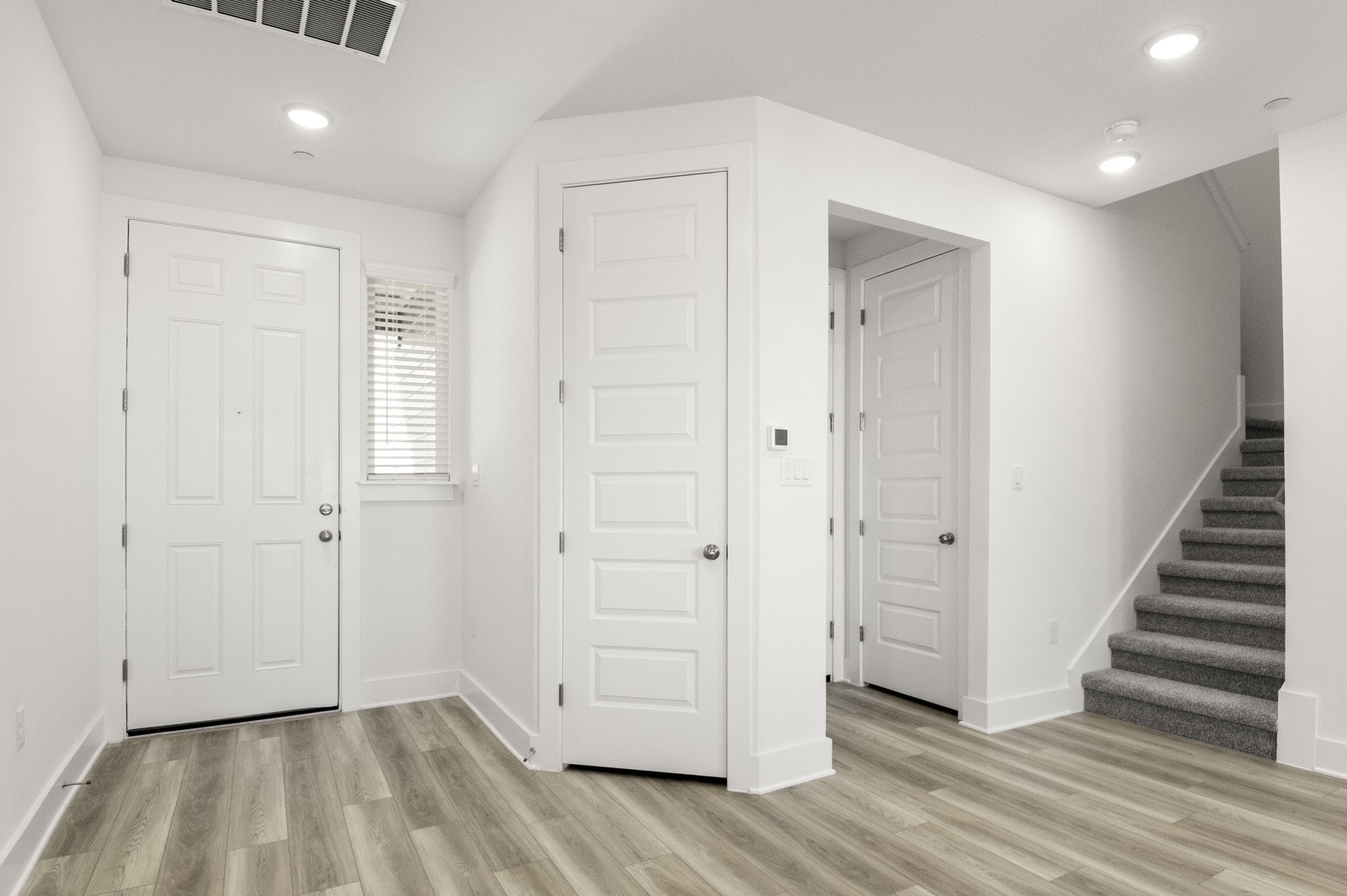 18909 Schultz Lane, Unit 1002 Round Rock, TX 78664 - Photo 4 of 24 Foyer featuring stairway, light wood-type flooring, and recessed lighting