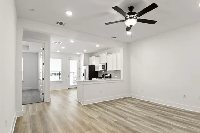 a view of a house with a wooden fence