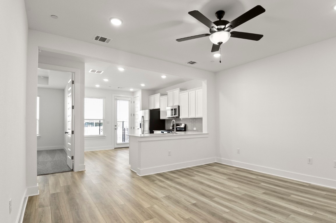 18909 Schultz Lane, Unit 1002 Round Rock, TX 78664 - Photo 24 of 24 a view of a kitchen with a sink and a refrigerator