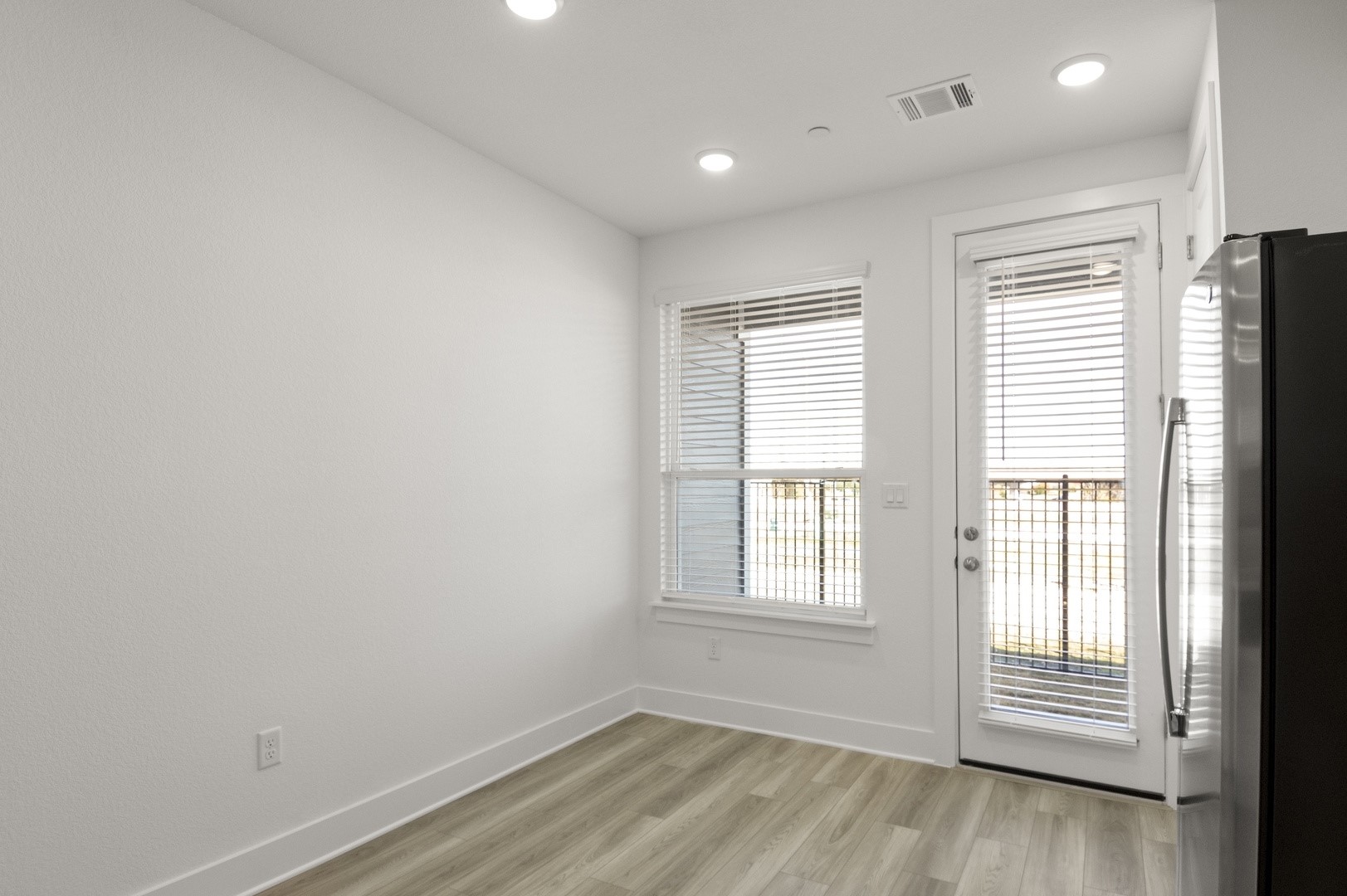 18909 Schultz Lane, Unit 1002 Round Rock, TX 78664 - Photo 9 of 24 Empty room with light wood-type flooring and recessed lighting