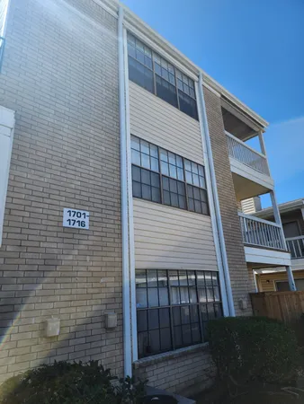 a view of a house with a big yard and large trees