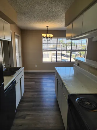 a view of empty room with wooden floor and fireplace