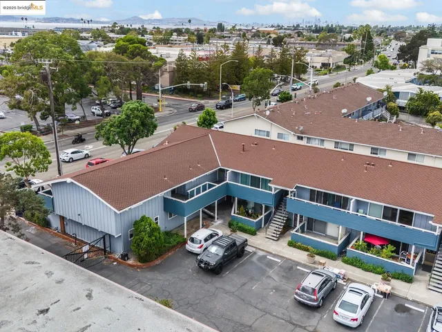 an aerial view of a house with garden space and street view