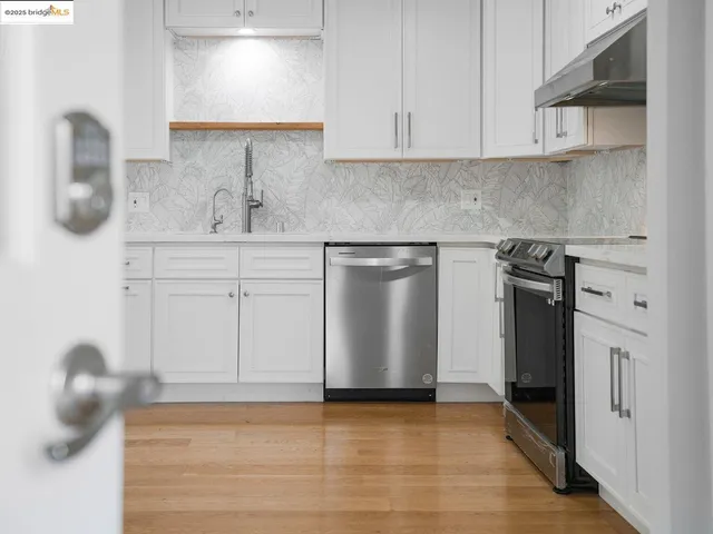a kitchen with cabinets and stainless steel appliances