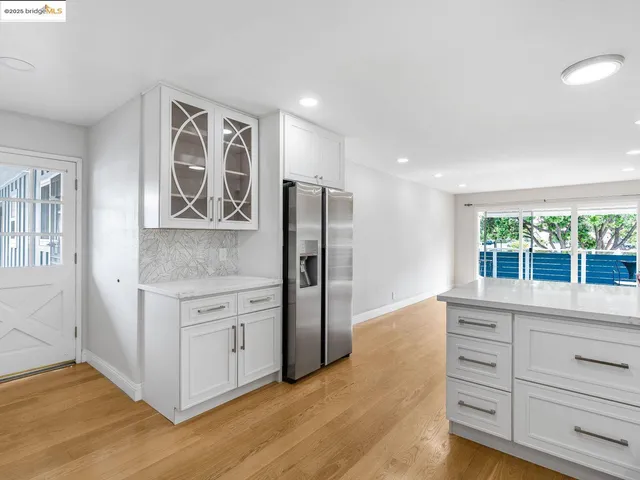 a kitchen with stainless steel appliances granite countertop a refrigerator and a stove top oven