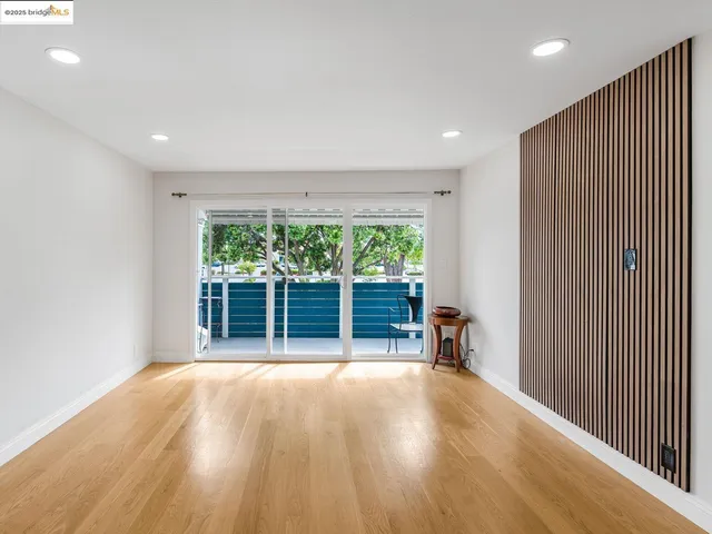 a view of a livingroom with furniture and floor to ceiling window