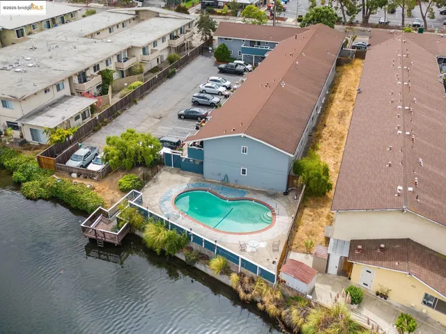 an aerial view of a house with a swimming pool and outdoor seating