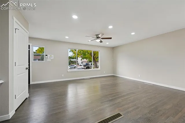wooden floor in an empty room with a window