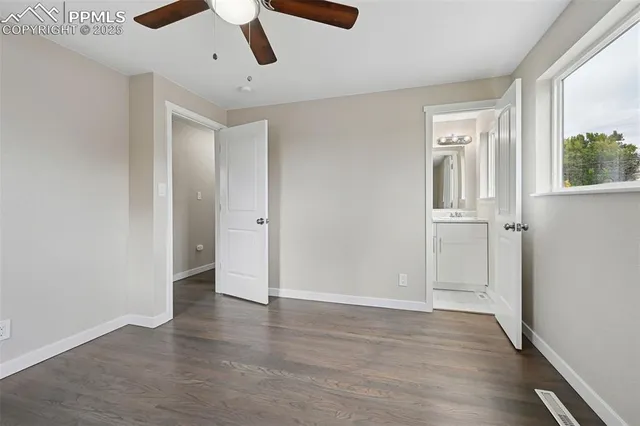 a bathroom with a toilet a sink a mirror a shower and vanity