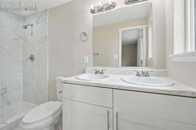 an empty room with a window and a ceiling fan