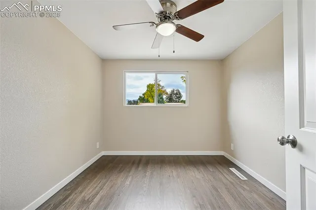 a view of an empty room and wooden floor