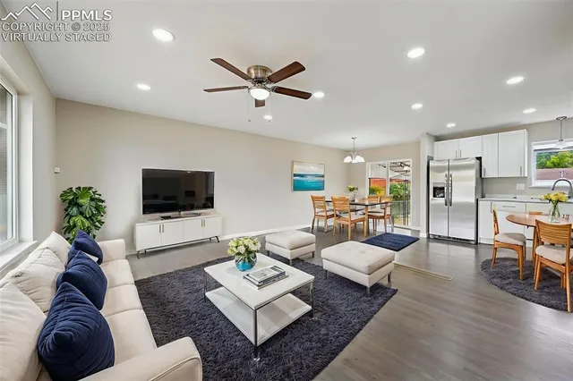 a living room with furniture a rug and a flat screen tv