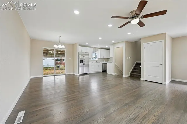 a view of a livingroom with a hardwood floor and a ceiling fan