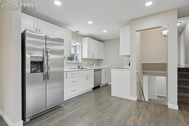 a kitchen with sink cabinets and a stove top oven