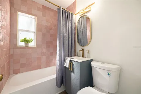 a bathroom with a sink a toilet and bathtub