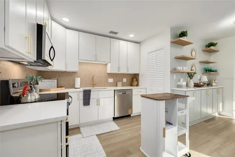 a kitchen with a sink cabinets and window