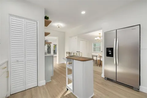 a kitchen with stainless steel appliances granite countertop a refrigerator and a sink