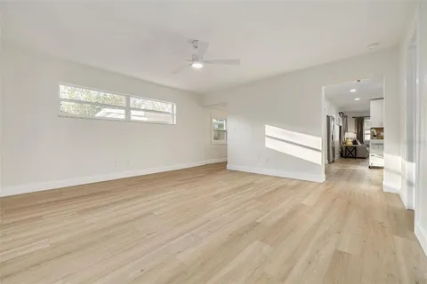 a view of empty room with wooden floor